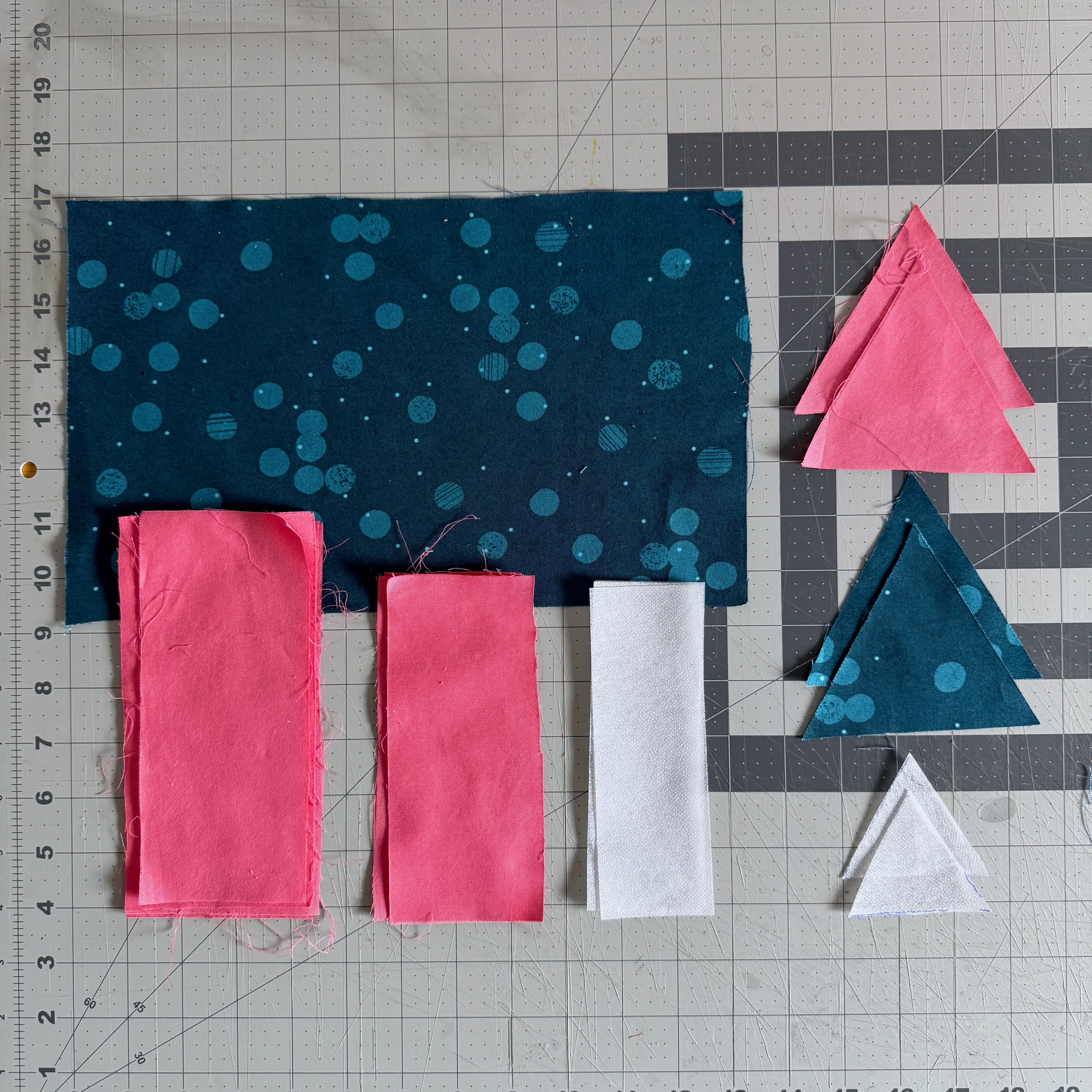 Patterned fabric, solid fabric, and fusible interfacing cut for the sunglasses case