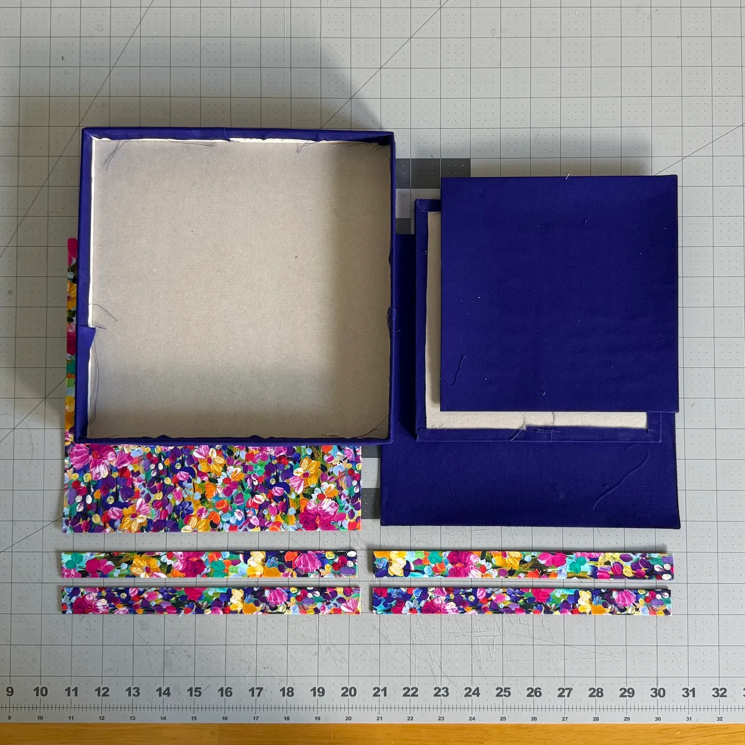 Valet tray structure and panels partially wrapped in purple and floral fabrics