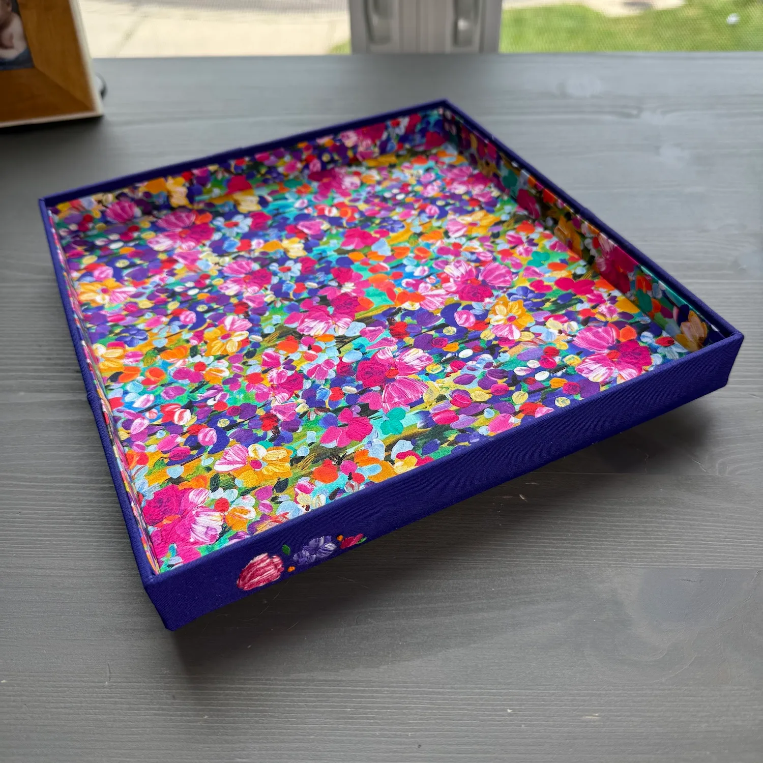 Finished floral fabric-covered valet tray viewed at an angle