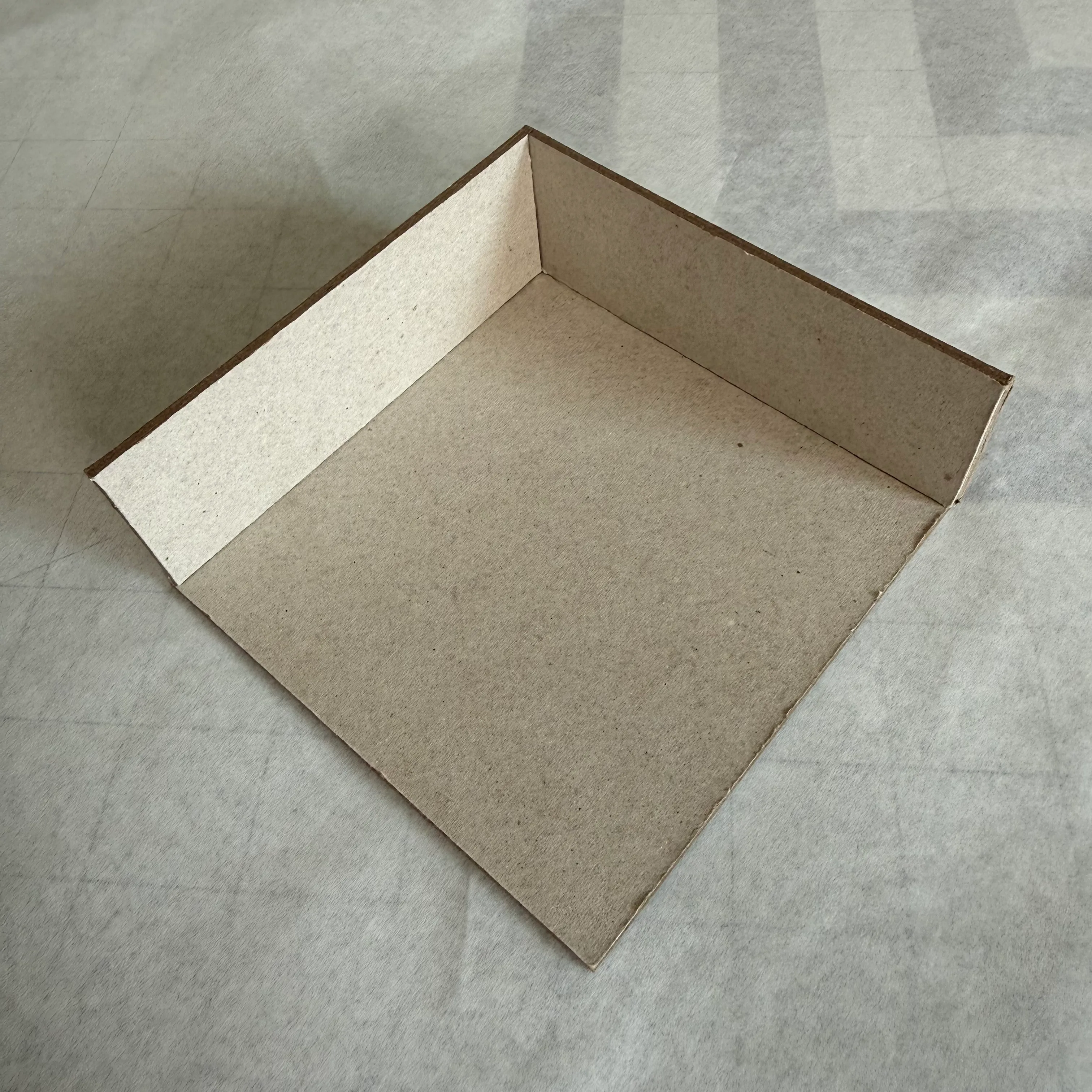 Chipboard walls partially assembled around the base