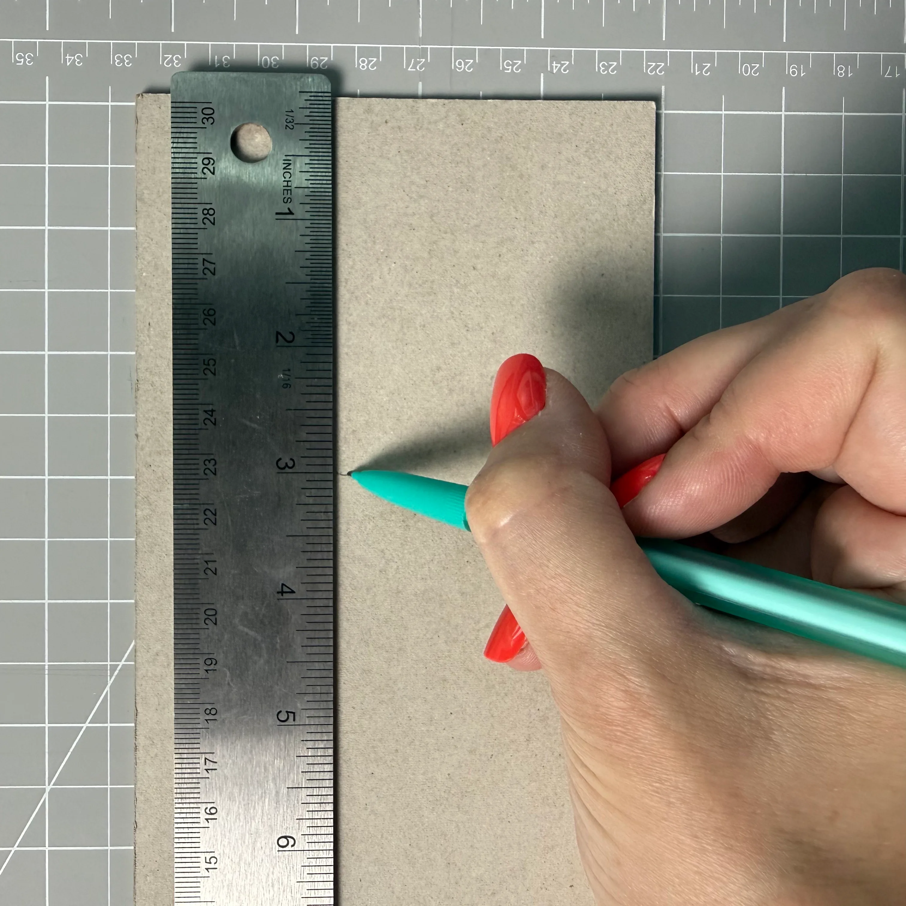 Measuring and marking a chipboard piece before cutting
