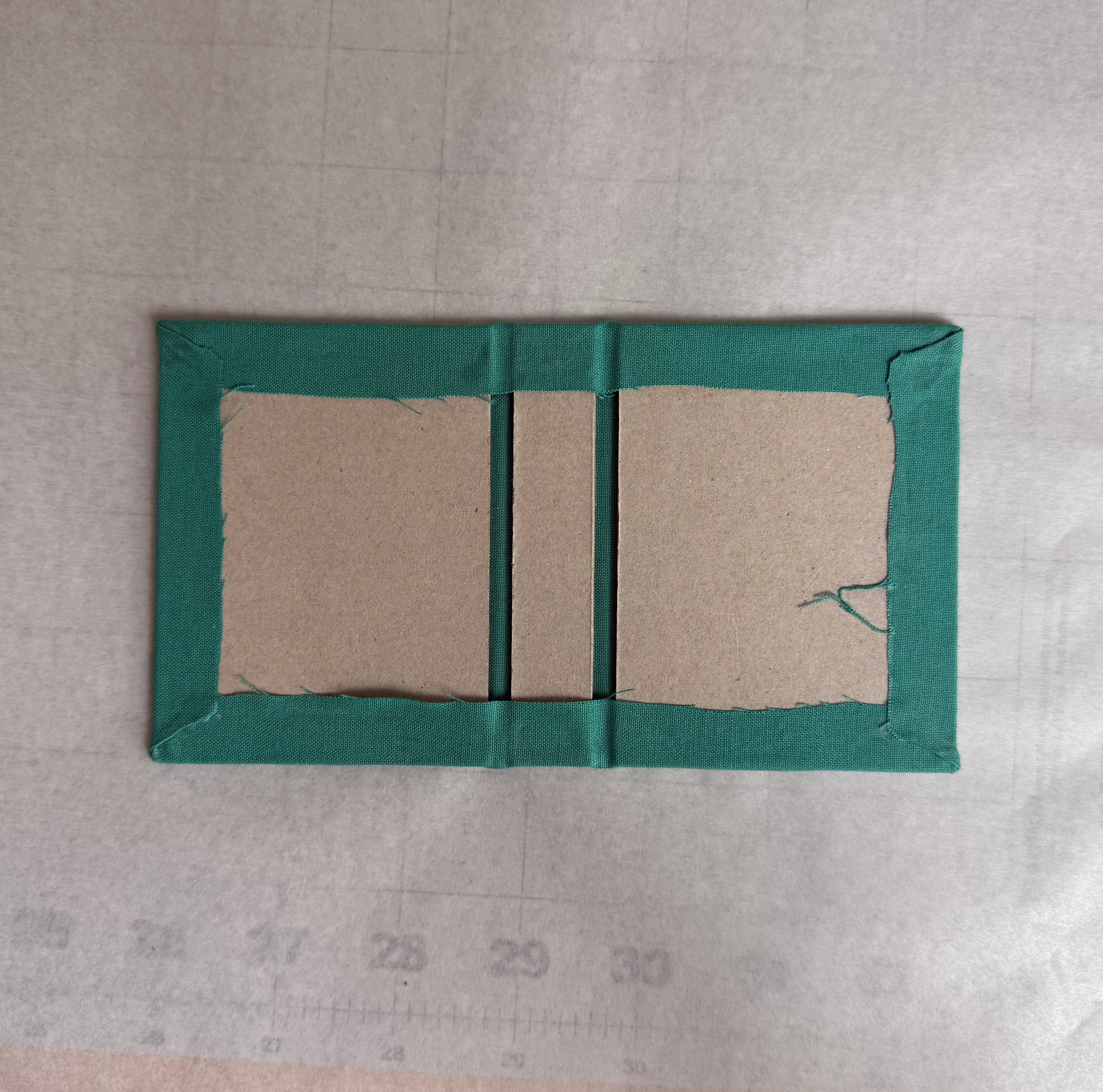Exterior fabric fully wrapped around the chipboard assembly
