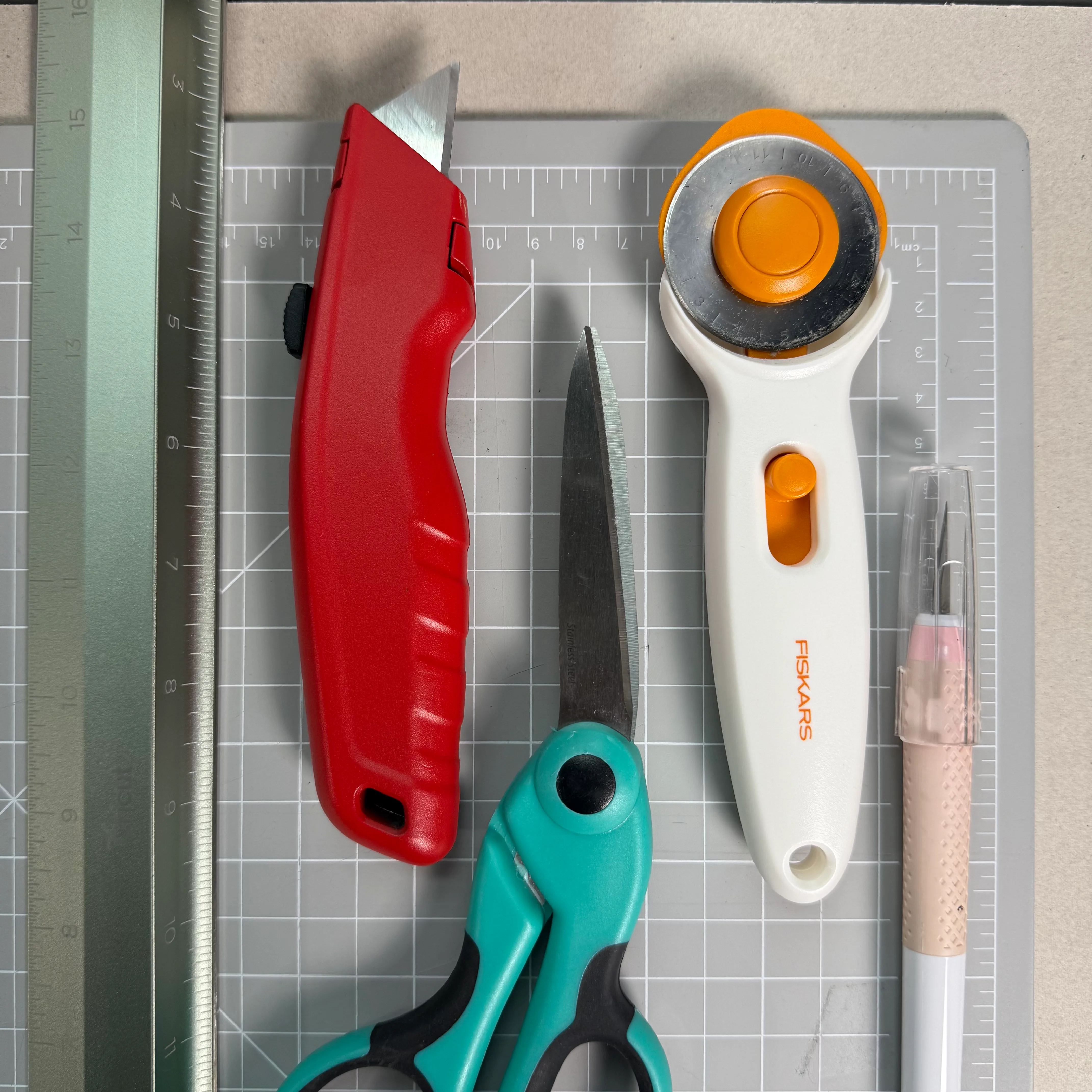 Rulers, knives, a cutting mat, and fabric-cutting tools