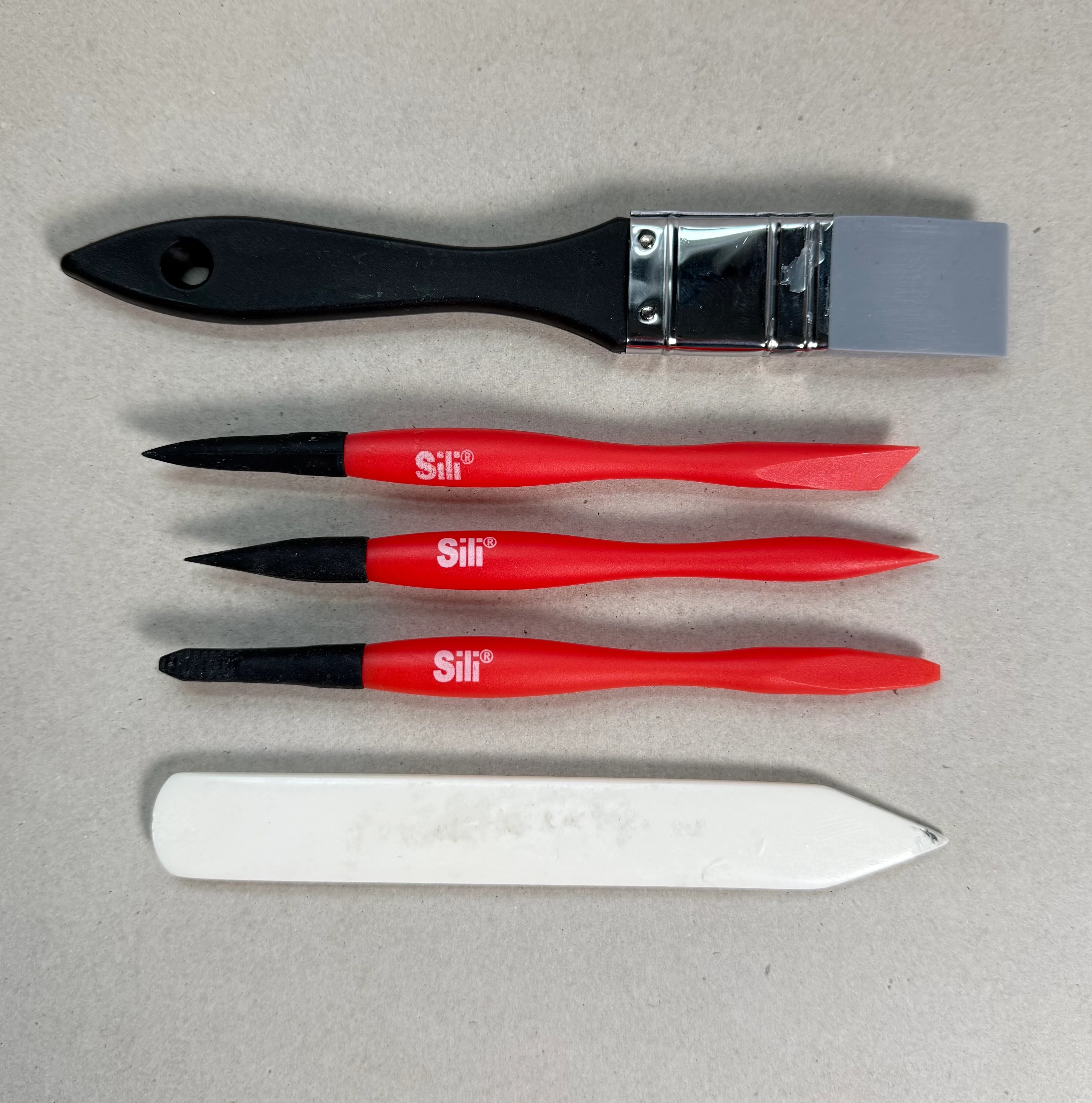 PVA glue, glue spreaders, and a bone folder