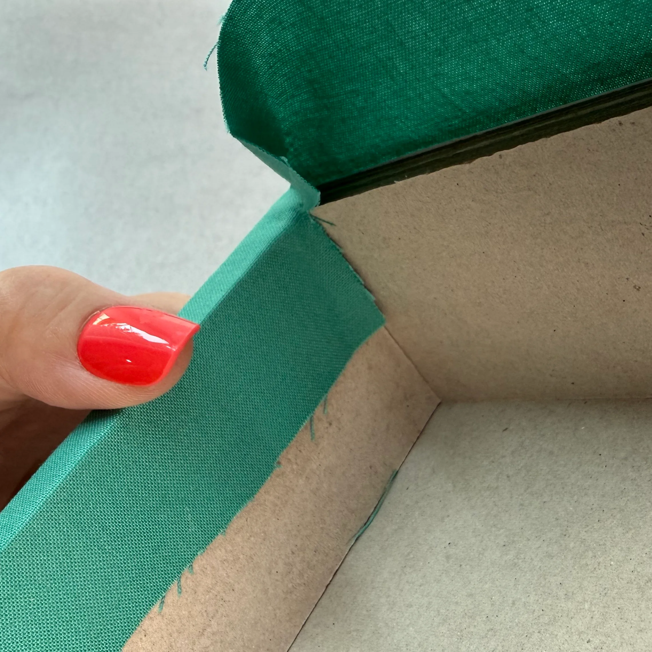 Folding the top fabric edge into the box
