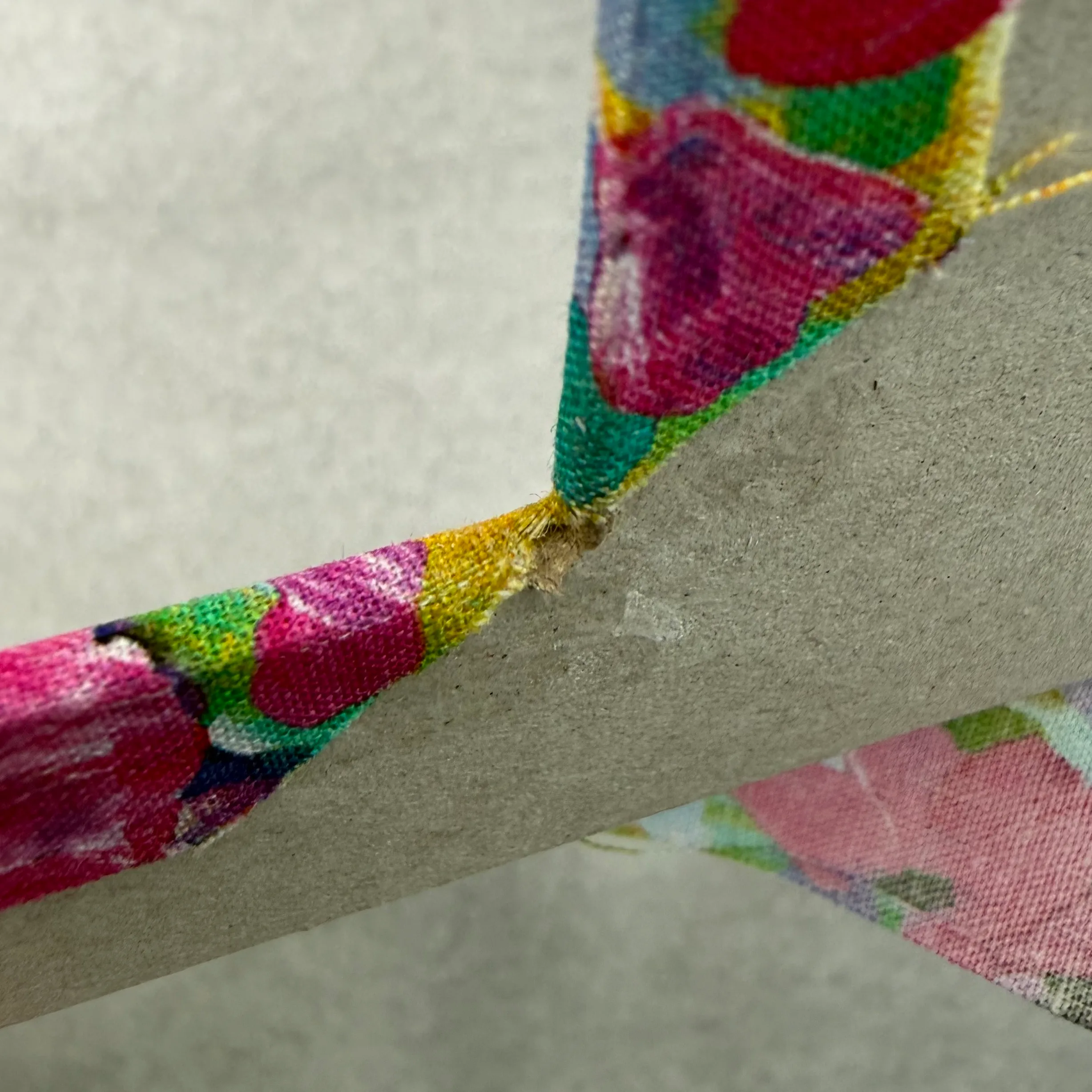 Smoothing fabric along an inner frame edge