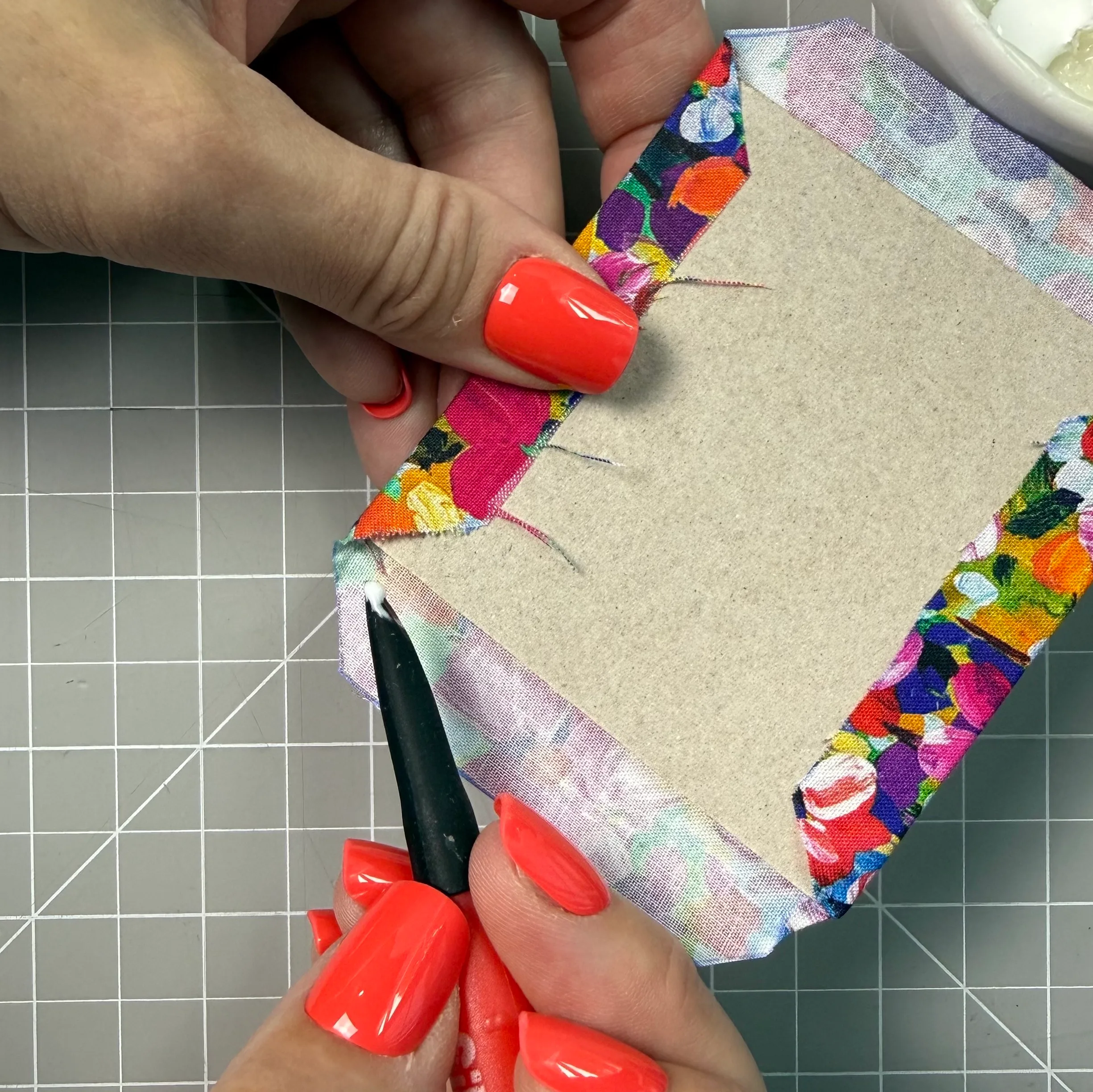Tucking fabric neatly at a chipboard corner