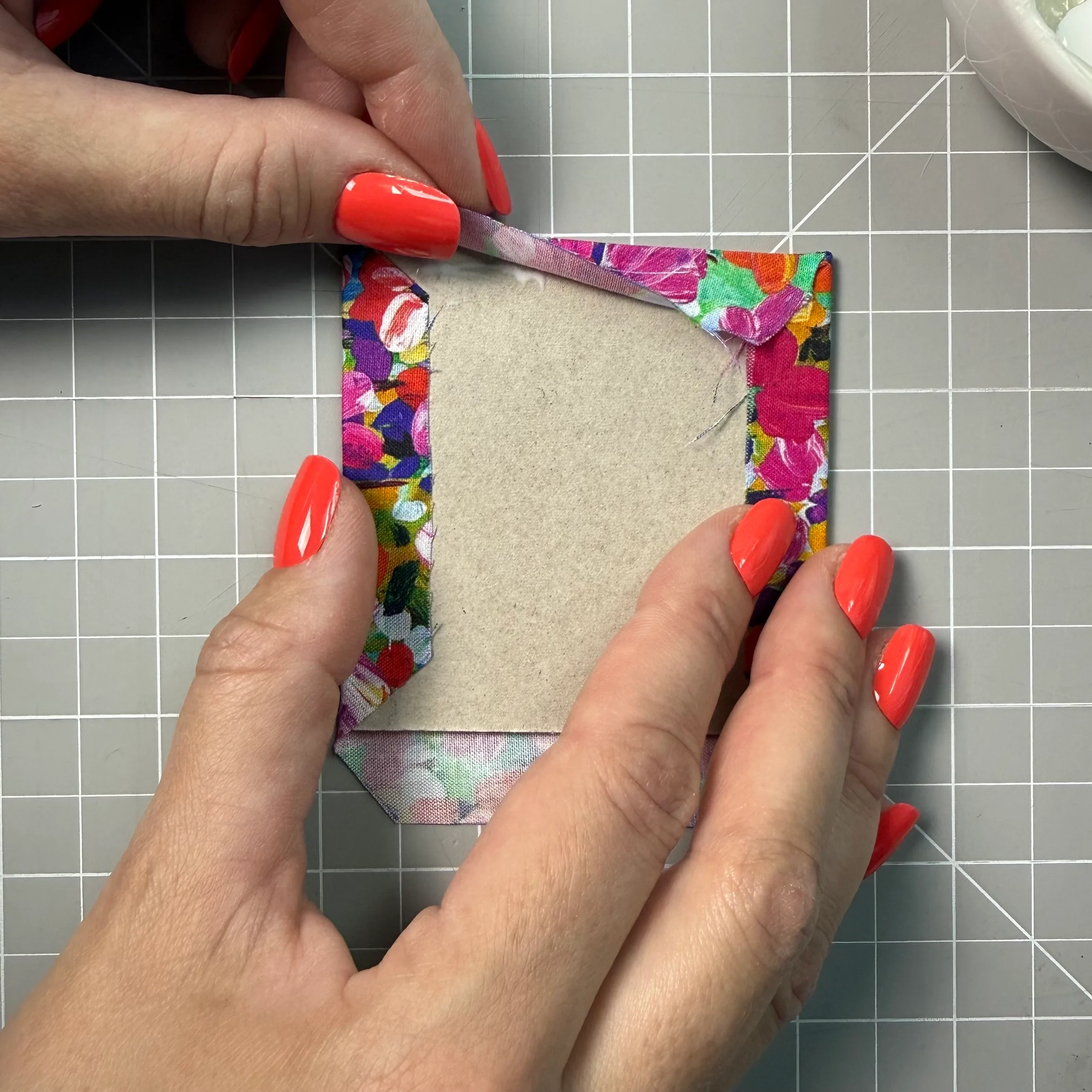 Wrapping the first fabric edge over a panel